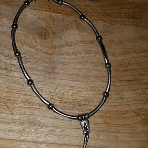 Black and silver necklace with tribal dangle.